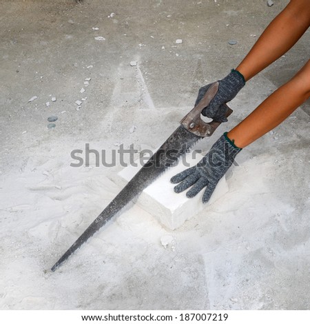 Workers are using a saw to cut Concrete to a smaller demand in building construction.