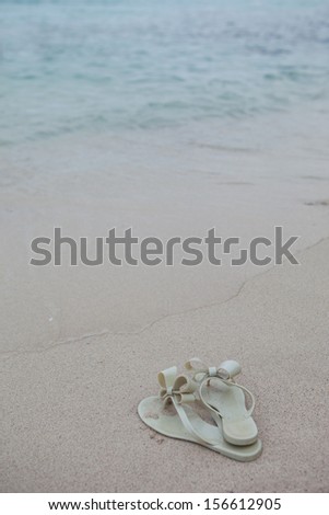 shoes on sand of beach beautiful sea At Kho-Lan Thailand