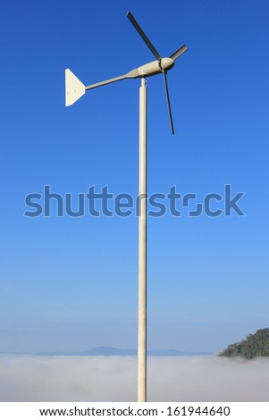 Wind turbines generating electricity whit blue sky and see fog