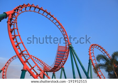 roller coaster loop at sunset.