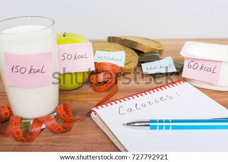 Counting calories, different food with written quantity of calories, diet concept.