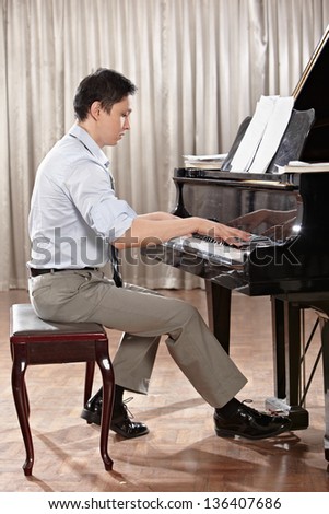 A young man playing piano on the stage