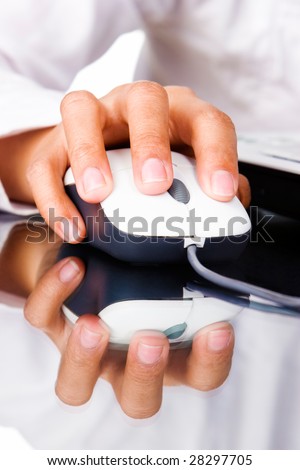 A hand holding a mouse with its index finger pressing the left button