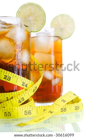 Close up of diet soft drinks concept using two glass of ice tea or cola surrounded by tape measure