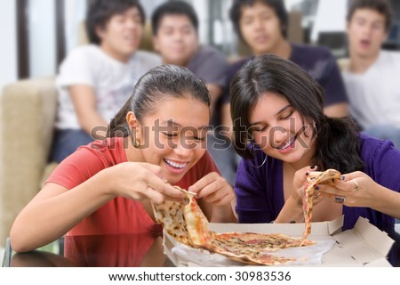 The girls got the first chance to eat pizza, while the boys looking at them jealously