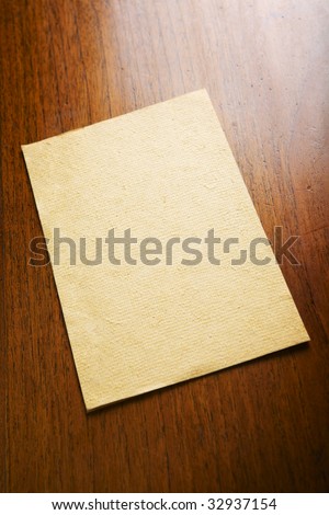 Old blank paper and a scroll on wooden table