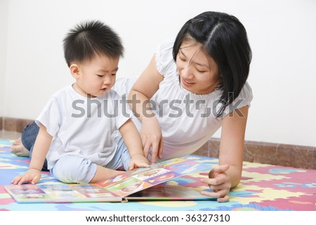 Asian mother tutoring her son for early education
