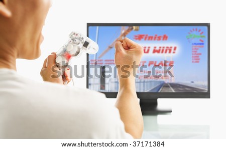 Man shouting in joy after winning the racing game holding a game-pad. The image and design on screen are mine.   *** PS for Inspector: this image was sticthed ***