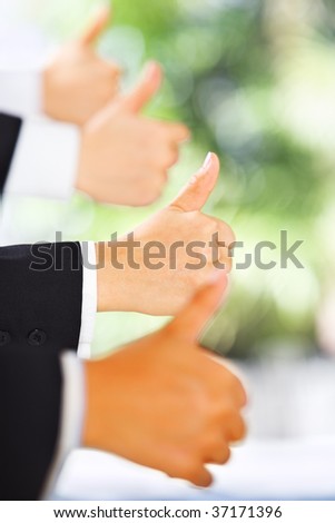 People raise thumbs up in line with green environment background