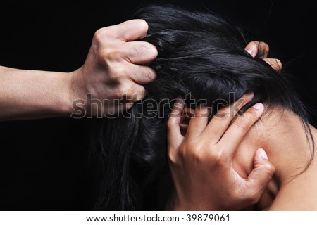 Hand grabbing woman\'s hair, concept for domestic violence