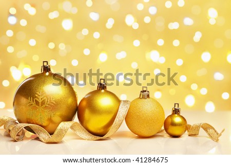 Golden Christmas ornaments with blur light on background