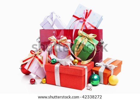 Pile of Christmas present with shopping bag, shot against white background
