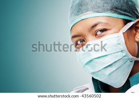 Female medical worker gazing to camera with all her protective wears