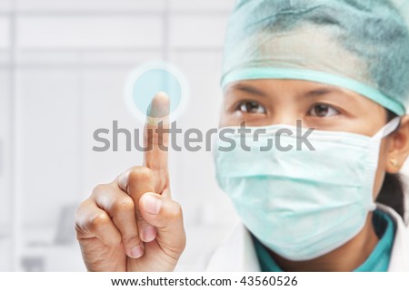 female medical worker or researcher or scientist touching virtual button panel