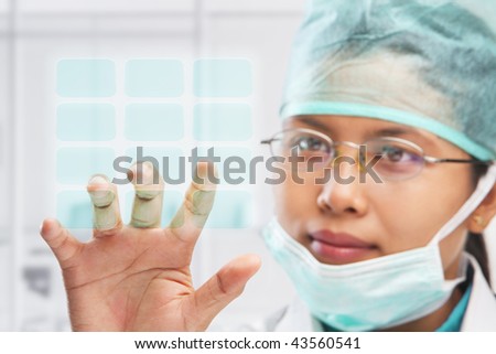 female medical worker or researcher or scientist touching virtual button panel