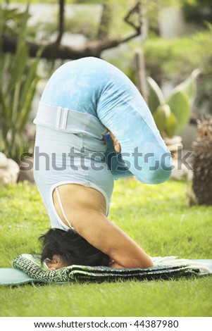 Asian senior old woman practicing yoga at garden