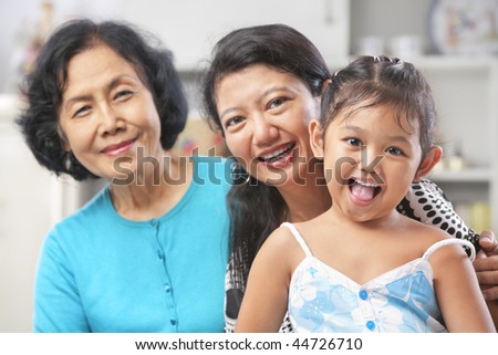 Three generation of Asian females posing at home starting from grandma, mother and daughter