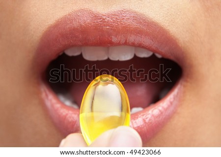 Woman mouth and capsule for health and medication concept