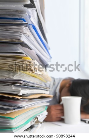 Lots of workload with people sleeping on background. PS: small depth of field and selective focus on papers