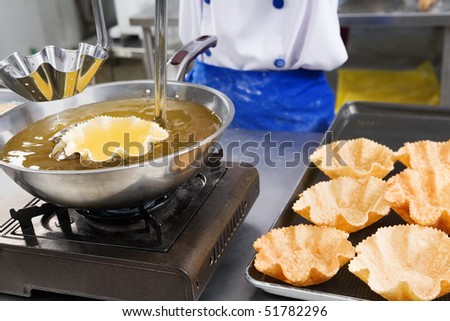Chef making a bowl to place the noodle in it from a wheat flour that shaped and deep fried