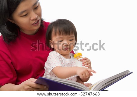 Chinese young woman story telling her cute daughter