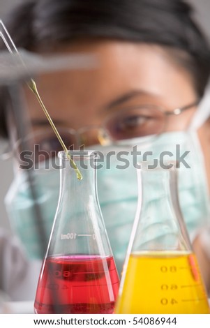 Female scientist mixing chemical solution in laboratory