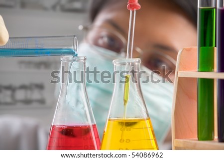 Female scientist mixing chemical solution in laboratory