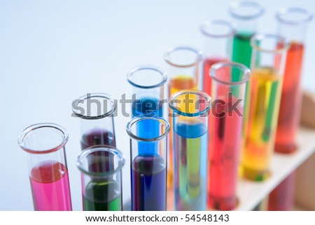 Test tube arranged in bluish background, with small copy space area