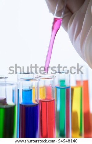 Mixing carefully chemical solution into the test tube