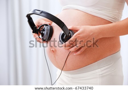 Stiimulating the fetus using music with a headset place on he stomach of pregnant woman