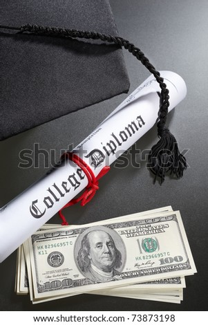 Graduation hat, and diploma certificate with a tack of US dollar bills for expensive education concept