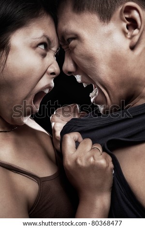 Asian couple having quarrel with physical contact