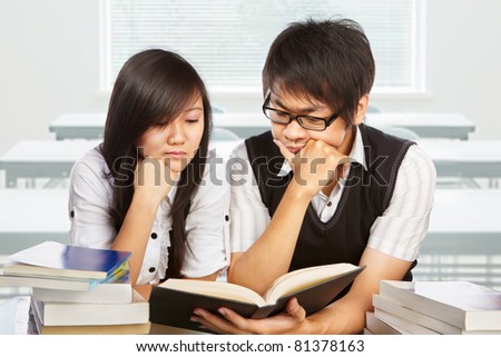 Male and female student studying together in the classroom
