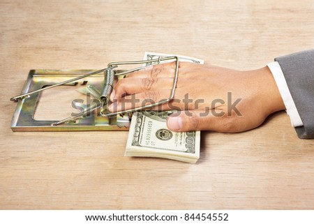 People hand trapped while catching the money placed on the mousetrap