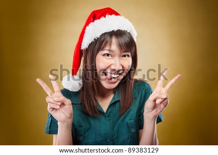 Asian lady using santa hat so excited pose to camera