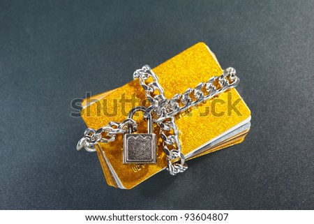 Stack of credit cards being surround by locked chain