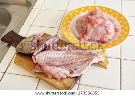 Raw fish being peeled and and meat taken to make fish cake