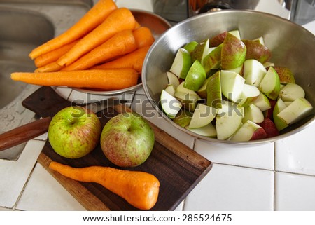 Fresh apple and carrot being prepared to be juiced