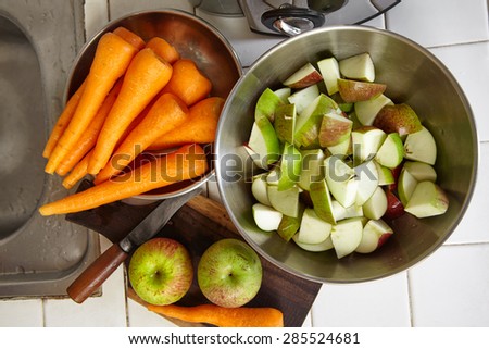 Fresh apple and carrot being prepared to be juiced