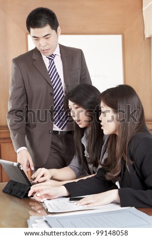 Manager helping his subordinate in the office