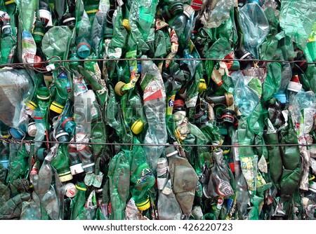 Green plastic bottles packed for recycling