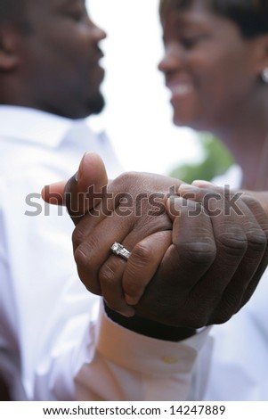 An african american couple in love. Shallow dof, focus is on hands