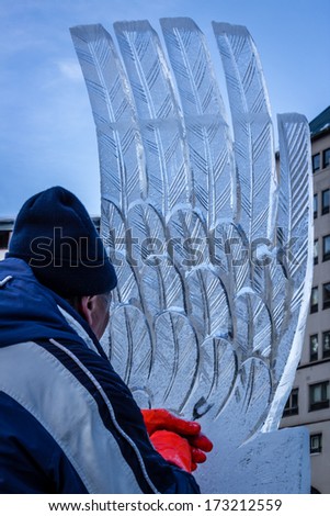 LAKE LOUISE, CANADA - JANUARY 18:  An ice sculptor carves a block of ice with a hand tool during the Lake Louise Ice Magic Festival , an annual event on January 18, 2014 at Lake Louise.