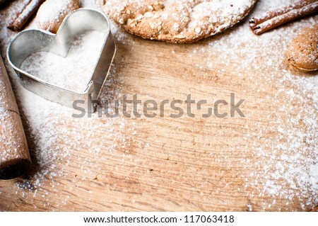 Christmas And Holiday Baking Background, Flour, Bakeware, Heart, Cinnamon, Cookies And Almonds On A Wooden Board, Viewed From Above