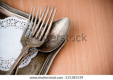 Vintage cutlery tray and old wooden board, close-up, food background