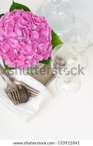 Bouquet of pink hydrangeas and vintage cutlery on the festive table closeup