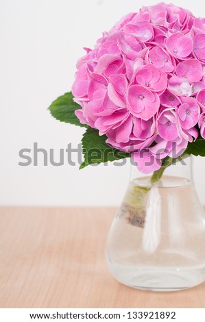 Bouquet of pink hydrangeas on a wooden table closeup