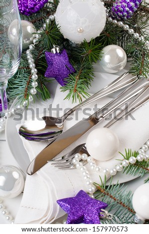 Festive Christmas table setting, table decoration in purple tones, with fir branches, Christmas balls on a white background, isolated