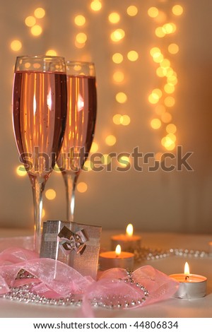 Two glasses of champagne and a gift with a holiday decoration in the St. Valentine's Day
