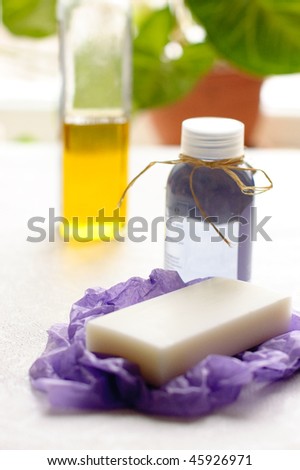 A bottle of lavender shower gel and white soap